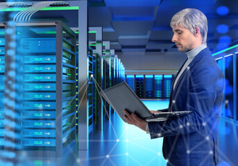 Data center operations, IT infrastructure management. Systems engineer monitors server racks with laptop, controlling network performance, cloud computing, and data security.