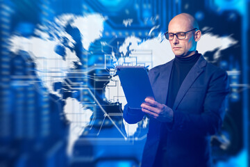 Global digital business and data analytics concept. Business professional uses tablet against world map and network interface, symbolizing international technology, data flow, and connectivity.