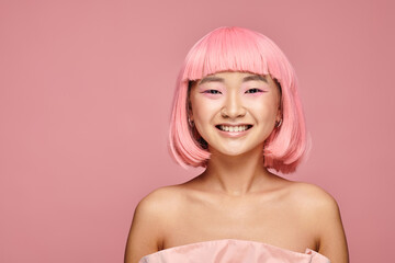 Young woman with vibrant pink hair radiates joy in a playful fashion setting
