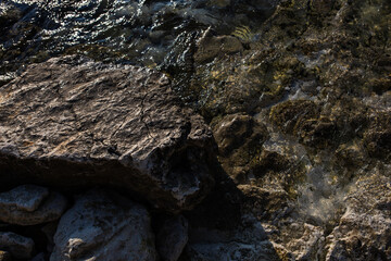 large stones near the seashore in the winter season. a stone beach in an environmentally friendly resort town. concept: tourism and beach recreation
