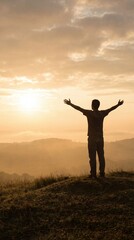 A silhouette of a person with outstretched arms against a golden sunrise, symbolizing freedom, hope, and connection with nature.