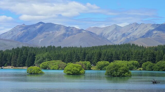 Berge, himmel mit Wolken im Vordergrund ein See mit Ufer und B&auml;umen, Lake Tekapo, Tekapo, Canterbury, S&uuml;dinsel, Neuseeland, Ozeanien