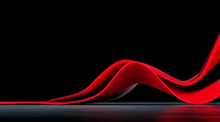 Red ribbon is shown in a black background. The ribbon is long and curvy, and it is a part of a larger design