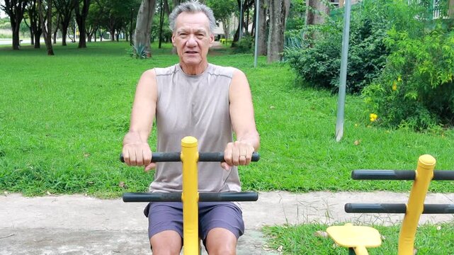 Slow Motion of an Older Man working out at an Outdoor Fitness Gym