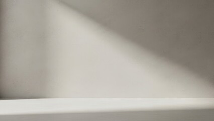 a simple abstract image showing a wall illuminated with bright angled sunlight and shadows