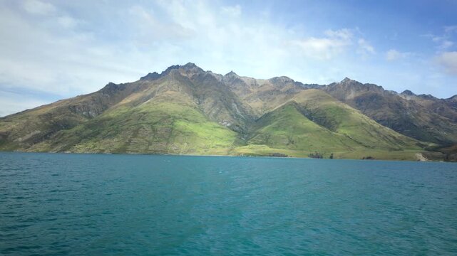 Boat Ride Past Turquoise Lake And Green Mountain Slopes