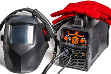Welding machine,electric welding mask and gloves on white background. Close up.