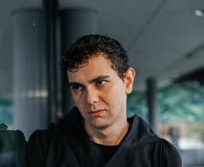 Obraz premium Pensive young caucasian male in black outfit indoors