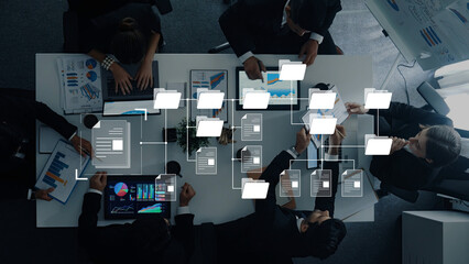 A dynamic business team engaging in collaborative data analysis with laptops and documents on a sleek meeting table, showcasing modern workspace elements. Trope