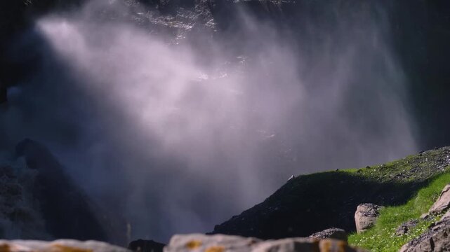 Close-up shot captures the immense volume of water and mist at the base of the majestic Chirkhalyu waterfall. The powerful cascade, located in the Khunzakh district of Dagestan, Russia, creates a thic