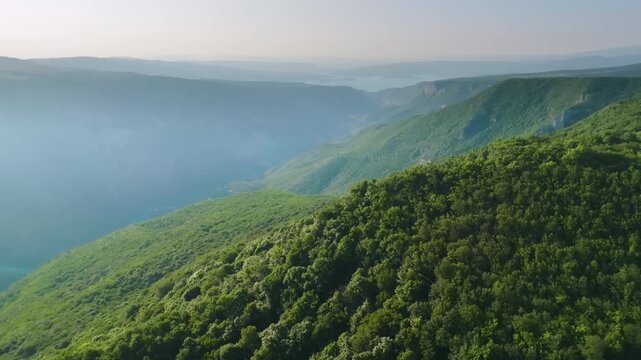 aerial panorama of the Sulak Canyon, one of the deepest canyons in the world and Europe, located in the North Caucasus mountains of Dagestan, Russia. The footage captures the vast natural landmark wit