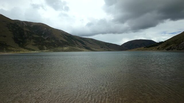 Calm Mountain Lake Under Dark Storm Clouds