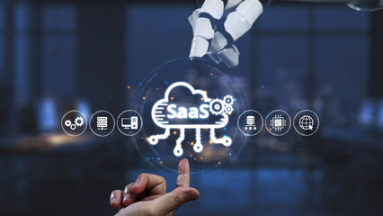 A futuristic robotic hand interacts with a SaaS interface in a modern office, symbolizing the integration of technology and cloud computing in business environments. Synapse