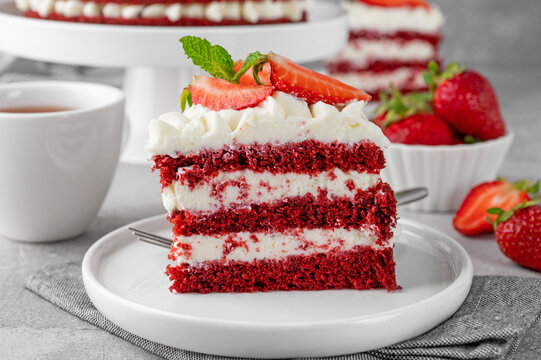 Naked Red velvet cake with fresh strawberries. Festive layered cake from red sponge cakes and cream cheese frosting. American cuisine.