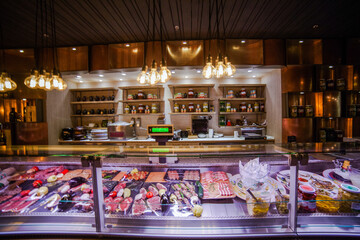 Deli counter showcasing fresh meats charcuterie and gourmet products