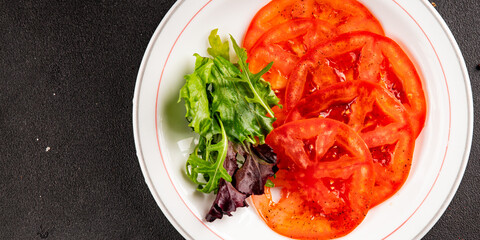 Tomato salad carpaccio sliced vegetables tasty snack fresh delicious gourmet food background on the table rustic food top view copy space keto and paleo diet vegetarian and vegan food