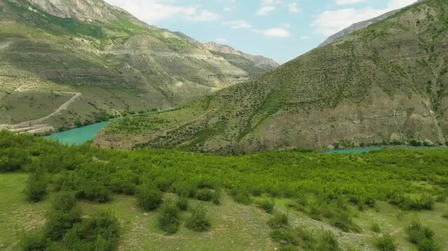Aerial drone footage captures the breathtaking natural beauty of the Sulak Canyon, located in the Republic of Dagestan, Russia. The deepest canyon in Europe is showcased with its vibrant, piercing tur