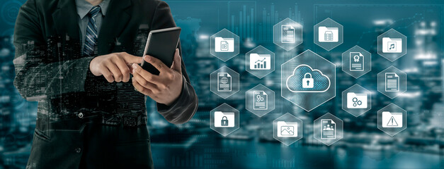 A businessman interacts with a smartphone while cloud security icons represent data protection strategies in a modern urban environment. Gantry
