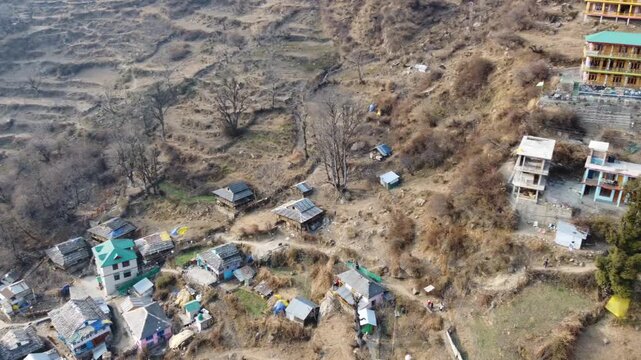 Aerial view of Tosh village nestled in Parvati Valley also cover Panoramic view of Tosh village at sunset, scenic mountains and pine forests in Kullu district, India.