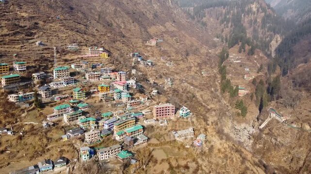 Aerial view of Tosh village nestled in Parvati Valley also cover Panoramic view of Tosh village at sunset, scenic mountains and pine forests in Kullu district, India.