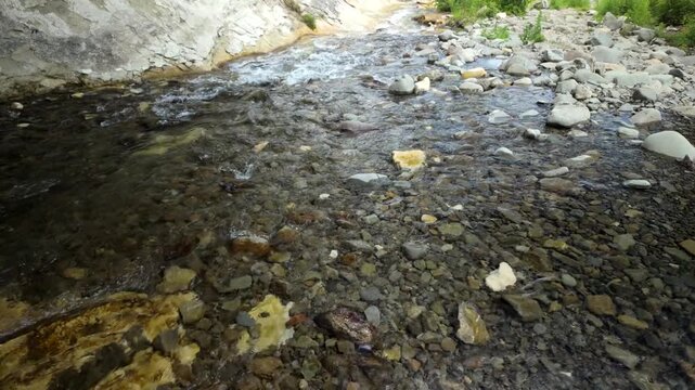 Shallow Creek Flowing Over Pebbles And Stones