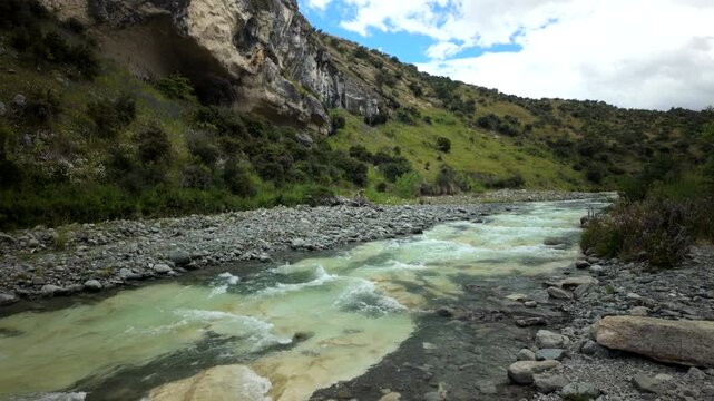 Milky Turquoise River Flowing Through Rocky Valley