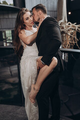 Couple shares an intimate moment inside a modern building during a special event