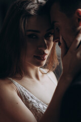 Naklejka premium Couple sharing an intimate moment in a soft light setting during an indoor evening