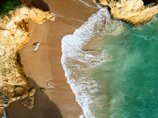 Aerial view of sea waves crashing on the shore, abstract nature landscape with light and water elements