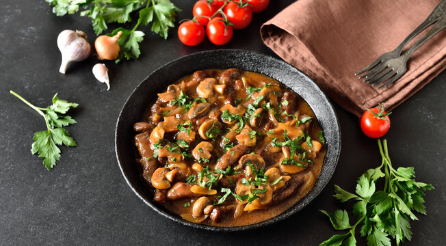 Beef stroganoff with mushrooms in frying pan