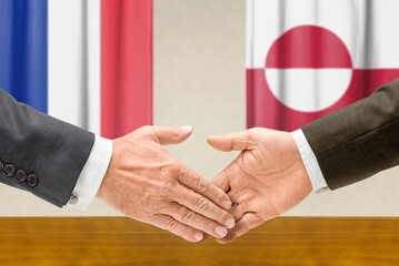 Symbolic cooperation concept &ndash; France and Greenland handshake