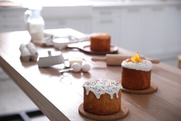 Traditional Easter cakes on table in kitchen, space for text