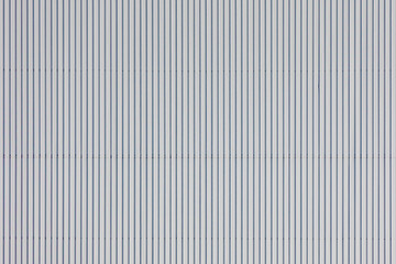 Obraz premium White zinc backdrop with vertical lines, Surface of zinc wall panels, Facade building material seamless pattern, Detail of galvanized texture, Metal sheet (Aluzinc) Abstract background.