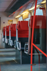 Fototapeta premium Stylish interior view of a modern passenger train with red seats and soft focus, conveying calm, efficiency, and modern public transportation