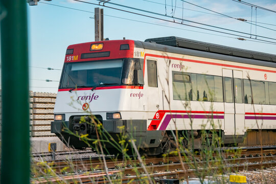 SPAIN, VALENCIA PROVINCE, VALENCIA, 15 JANUARY, 2026. Passenger train RENFE moving on railway tracks, side view. Modern public transport, daily rail travel.