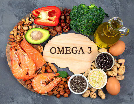 Wooden brain-shaped board with 'OMEGA 3', surrounded by salmon, avocado, spinach, broccoli, nuts, seeds, olive oil and eggs; neutral background, natural lighting, photographic style.