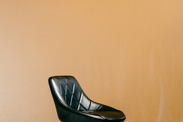 black bar stool with a small backrest