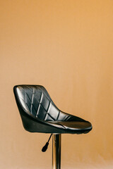 black bar stool with a small backrest