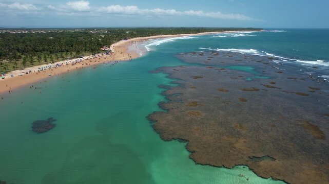 Natural pools in the sea off Taipu de Fora beach, a tourist spot on the Mara&uacute; Peninsula, coast of Bahia, Brazil, panoramic aerial view, coconut trees, blue and green sea, paradisiacal