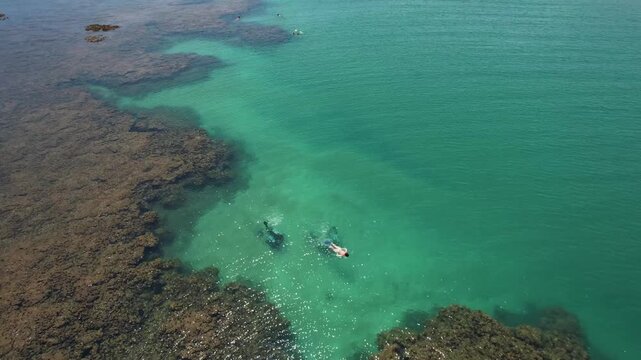 Natural pools in the sea off Taipu de Fora beach, a tourist spot on the Mara&uacute; Peninsula, coast of Bahia, Brazil, panoramic aerial view, coconut trees, blue and green sea, paradisiacal