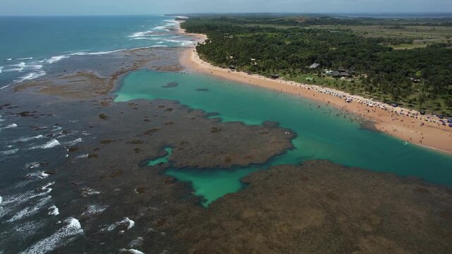 Natural pools in the sea off Taipu de Fora beach, a tourist spot on the Mara&uacute; Peninsula, coast of Bahia, Brazil, panoramic aerial view, coconut trees, blue and green sea, paradisiacal