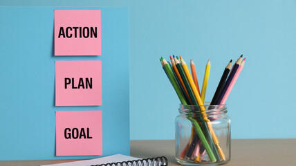 Colorful Pencils in Glass Jar with Action Plan Sticky Notes in Pastel Blue Background for Office Supplies