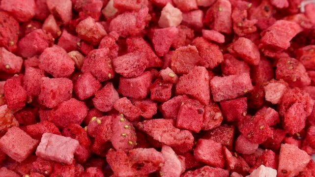 Red freeze dried strawberry slices texture circle rotation close up