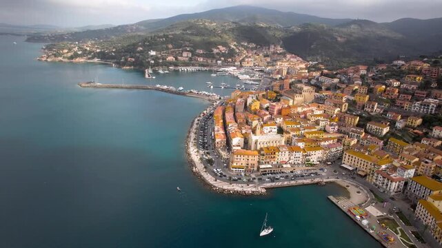 coastal Tuscany Italy 4K Aerial orbit of Porto Santo Stefano town and harbor in Monte Argentario , cinematic drone