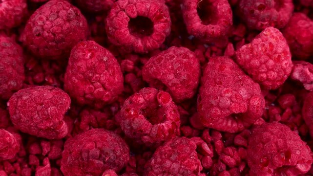 Red whole freeze dried raspberry berries circle rotation close up