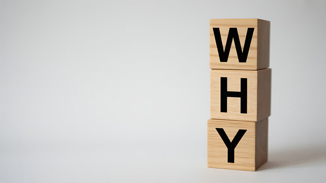 Stack of wooden blocks spelling the word WHY on a neutral light background with copy space, concept of questioning, purpose, and curiosity