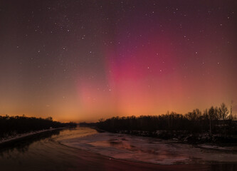 Fototapeta premium Aurora borealis in the night in Poland. Night sky with stars, clouds and Aurora Borealis.