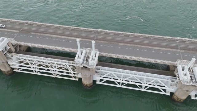 massive coastal defense infrastructure connects land cluster towering wind turbines small harbor inlet located eastern scheldt storm surge barrier netherlands to near 