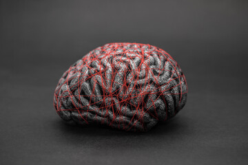 Human brain entwined with red thread. Concept of neurology, nervous system or human mind.