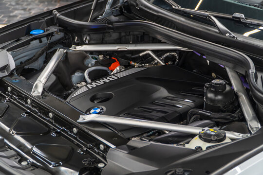 BMW BMW X7 G07 M60i engine - hybrid, plug-in V8 engine. Engine motor M POWER of BMW XM 50e close-up with emblem. BMW sport engine or motor under vehicle hood.